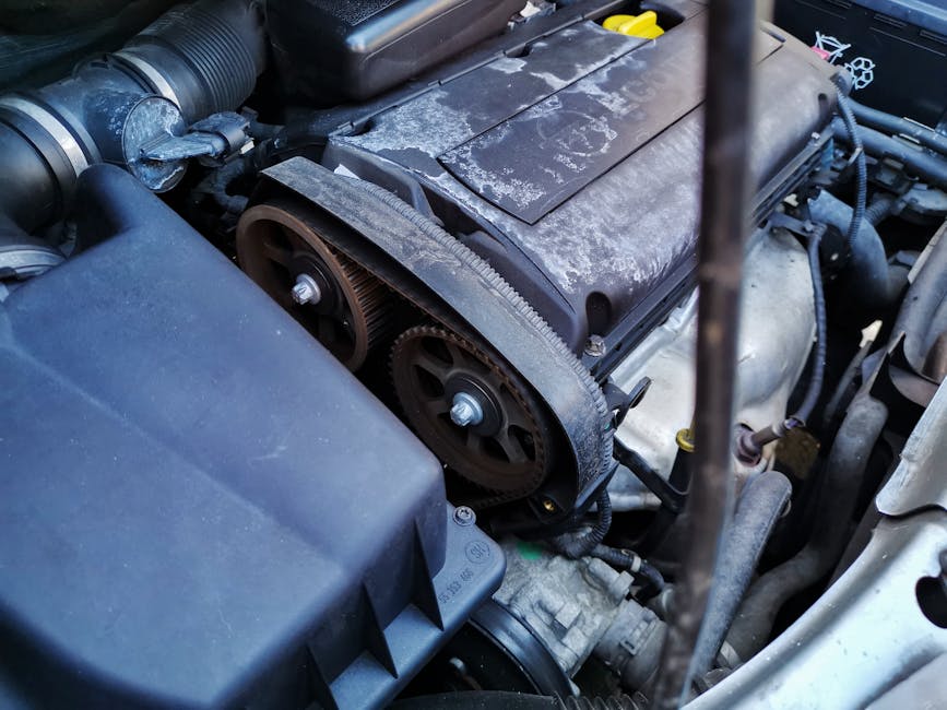bobo_timing_belt_water_pump Detailed close-up of a car engine focusing on the belts and components under the hood.